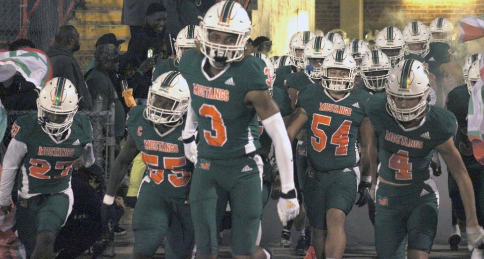 Mandarin cornerback Antoine Belgrave-Shorter (3) and teammates run onto the field before an FHSAA Region 1-4M high school football quarterfinal against Sanford Seminole on November 14, 2022. [Clayton Freeman/Florida Times-Union]