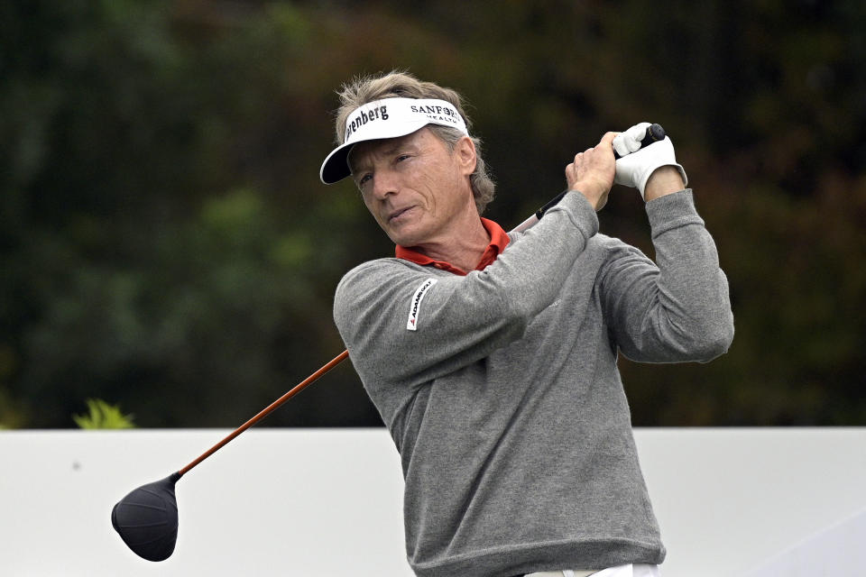 FILE - Bernhard Langer, of Germany, warms up before his tee shot on the first hole during the final round of the PNC Championship golf tournament in Orlando, Fla., in this Sunday, Dec. 20, 2020, file photo. The 2021 Senior PGA Championship at Southern Hills Country Club begins Thursday. Bernhard Langer holds a slight lead over Ernie Els at the top of the money list. Kevin Sutherland has the highest all-around ranking and is third on the money list. (AP Photo/Phelan M. Ebenhack, File)