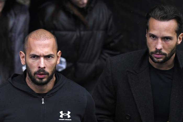 Andrew Tate (left) and his brother Tristan leave after appearing at the Court of Appeal, in Bucharest, Romania, on Jan. 10, 2023.