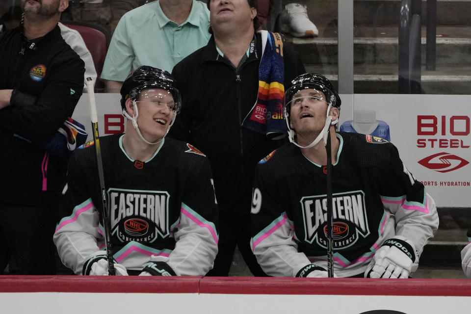 FILE - Atlantic Division's Brady Tkachuk, of the Ottawa Senators (7) and Matthew Tkachuk, of the Florida Panthers (19) watch the rerun of a goal by Matthew assisted by Brady during the NHL All Star hockey game, Saturday, Feb. 4, 2023, in Sunrise, Fla. There are 20 sets of brothers that have played in the league this season. (AP Photo/Marta Lavandier, File)