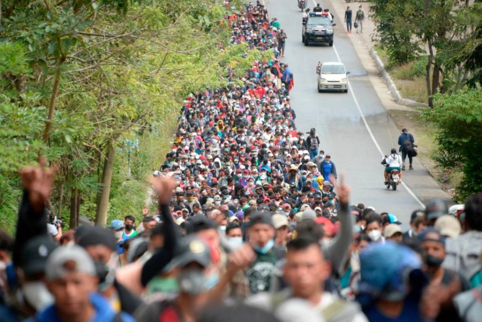 Honduran migrants, part of a caravan heading to the United States, walk along a road in Camotan, Guatemala on January 16. Source: Getty