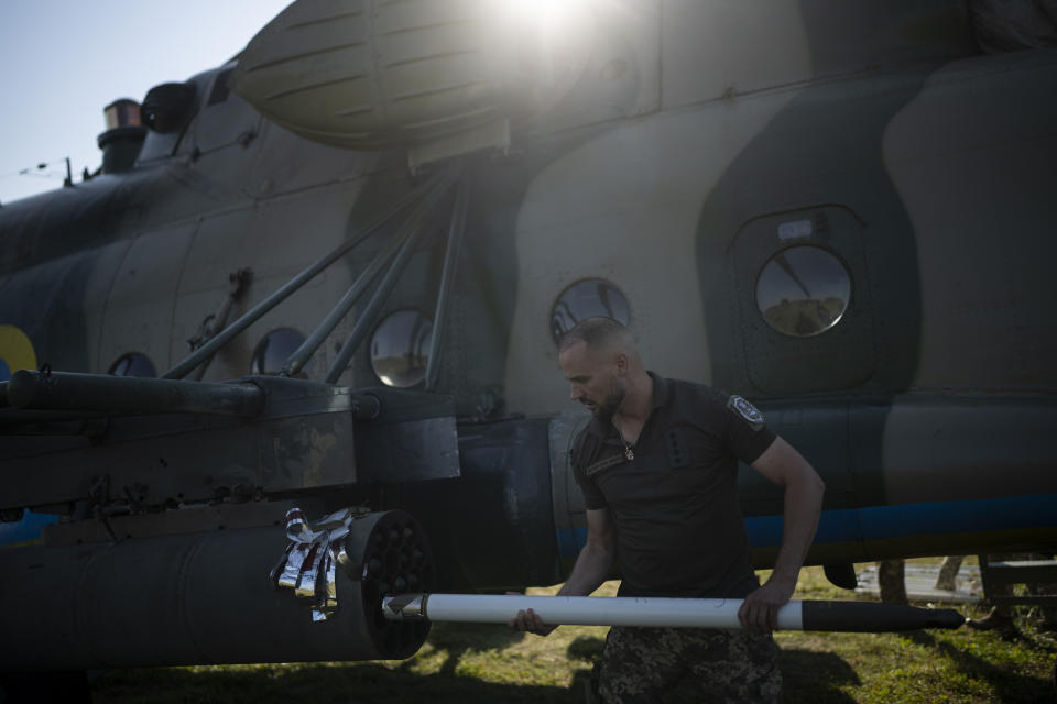 FILE - A Ukrainian soldier loads a shell onto an attack helicopter in eastern Ukraine, Friday, Aug. 18, 2023. Moscow’s army is staging a ferocious push in northeast Ukraine designed to distract Ukrainian forces from their counteroffensive and minimize the number of troops Kyiv is able to send to more important battles in the south.(AP Photo/Bram Janssen, File)