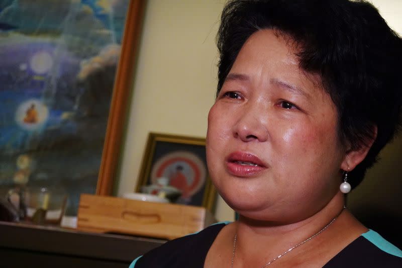 Yang Xiaolan cries during an interview at her home in Hong Kong