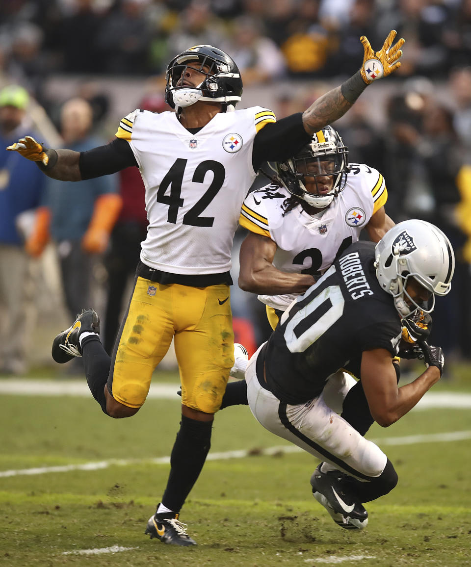 <p>Oakland Raiders wide receiver Seth Roberts (10) catches a pass in front of Pittsburgh Steelers strong safety Morgan Burnett (42) and strong safety Terrell Edmunds (34) during the second half of an NFL football game in Oakland, Calif., Sunday, Dec. 9, 2018. (AP Photo/Ben Margot) </p>