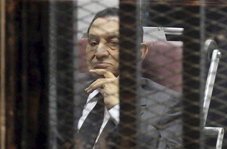 Egypt's ousted President Hosni Mubarak looks on as he reacts inside a dock at the police academy on the outskirts of Cairo May 21, 2014. REUTERS/Stringer