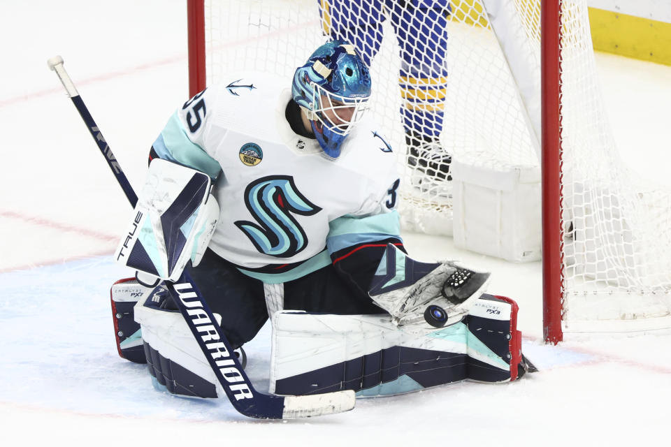 Seattle Kraken goaltender Joey Daccord makes a glove save during the third period of the team's NHL hockey game against the Buffalo Sabres on Tuesday, Jan. 9, 2024, in Buffalo, N.Y. (AP Photo/Jeffrey T. Barnes)