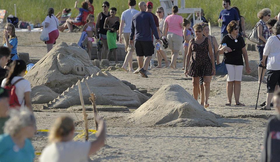 Crowds look at sand sculptures on Presque Isle State Park's Beach 11 during Discover Presque Isle on July 29, 2017.