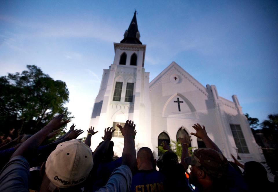 A crowd prays outside the Emanuel AME Church after a memorial service for the nine people killed in a racist attack at the church in Charleston, S.C., June 19, 2015.<span class="copyright">Stephen B. Morton—AP</span>