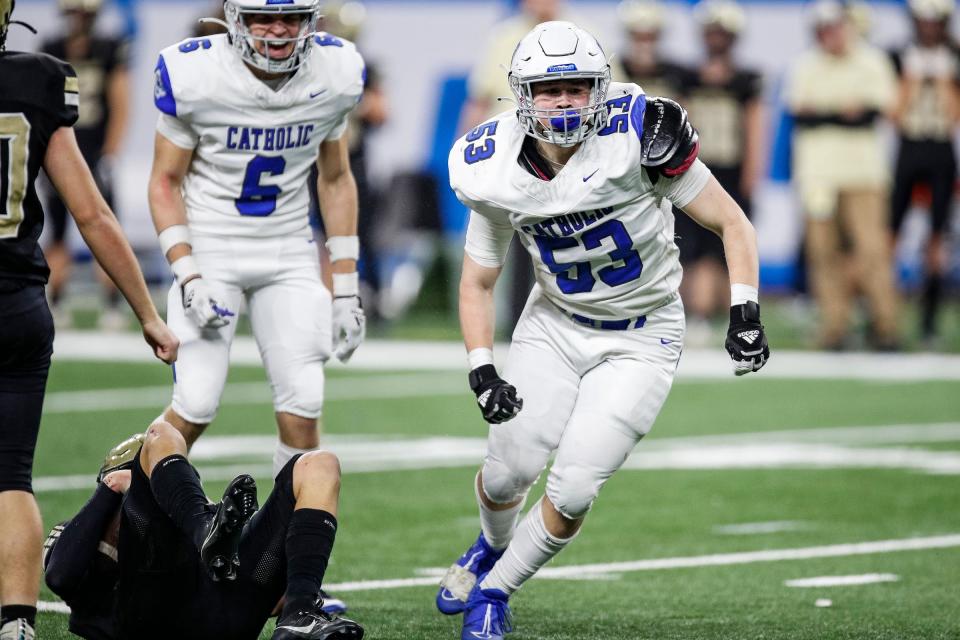 Grand Rapids Catholic Central defensive line Adam Whalen celebrates a tackle against Corunna during the first half of the Division 5 football state final on Sunday, Nov. 26, 2023, at Ford Field.