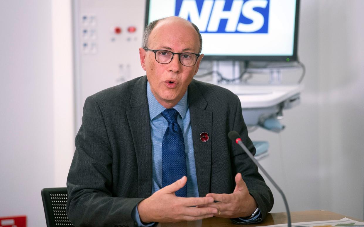 Sir Stephen speaks into a microphone at an NHS press conference