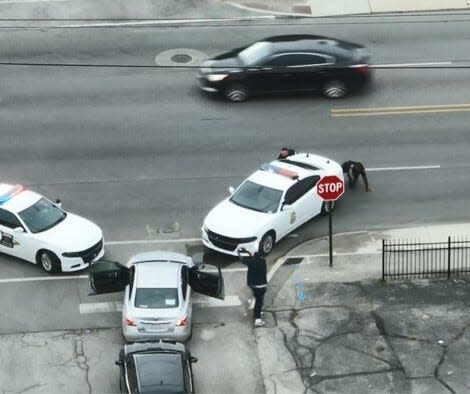 A police drone flying overhead captured this image of a traffic stop during which police shot and killed a man near East 40th Street and North Keystone Avenue on Sept. 26, 2023.