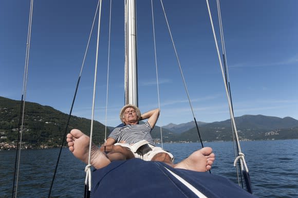 An man napping on a sail boat.