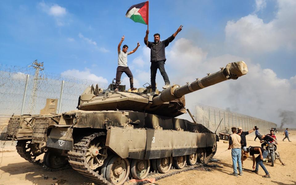 Palestinians on a captured Israeli tank in Gaza City