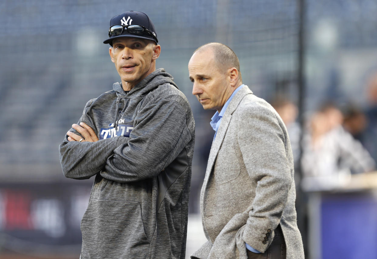 Joe Girardi and Brian Cashman weren’t on the same page. (AP Photo/Kathy Willens, File)