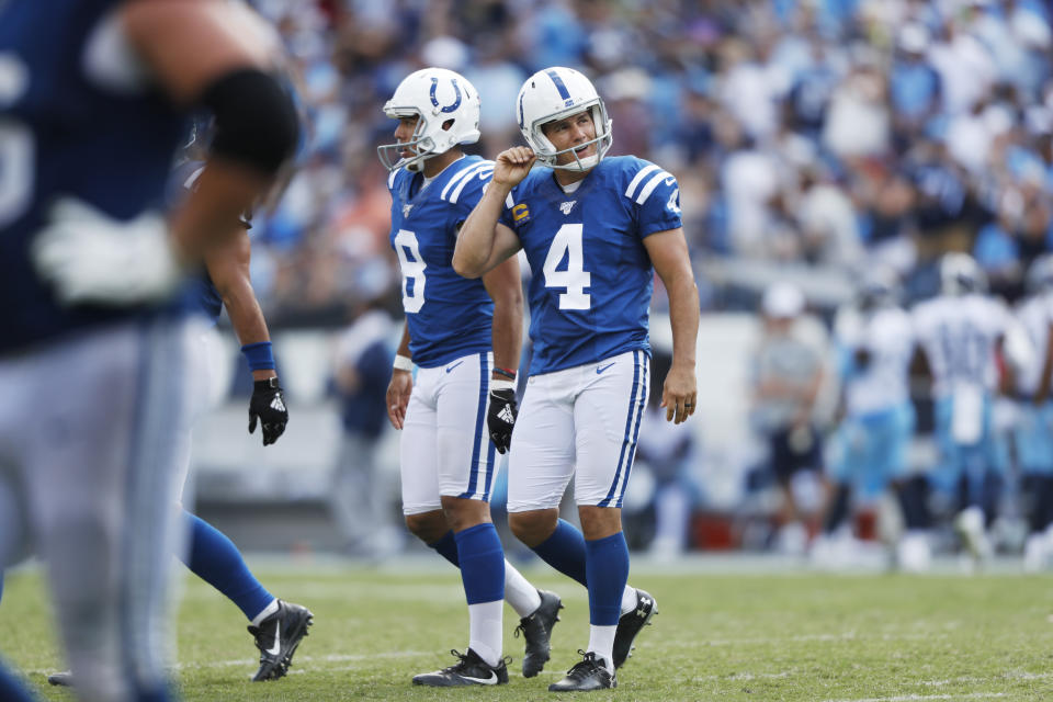 Indianapolis Colts kicker Adam Vinatieri (4) walks to the sideline with holder Rigoberto Sanchez after Vinatieri missed his second extra point of the game against the Tennessee Titans in the second half of an NFL football game Sunday, Sept. 15, 2019, in Nashville, Tenn. (AP Photo/Wade Payne)