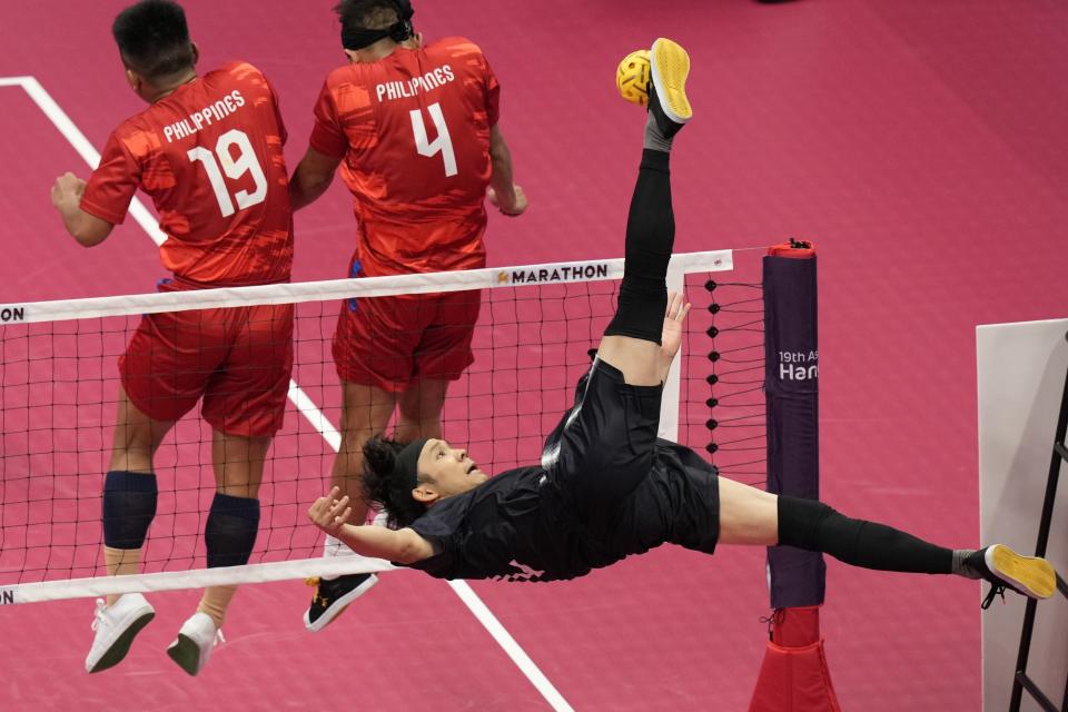 Japan's Yota Ichikawa returns a ball during men's sepaktakraw preliminary Group B match against Philippines at Jinhua Sports Centre at the 19th Asian Games in Jinhua, China, Sunday, Oct. 1, 2023. (AP Photo/Eugene Hoshiko)