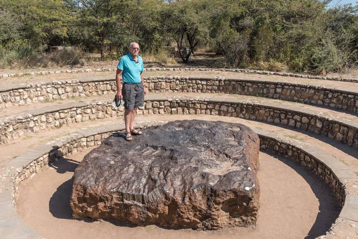a man standing on the meteorite
