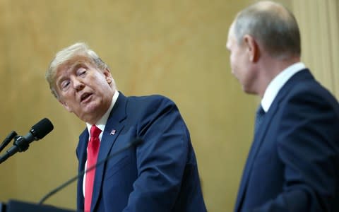 Donald Trump turns towards his Russian counterpart Vladimir Putin at Helsinki summit - Credit: TASS / Barcroft