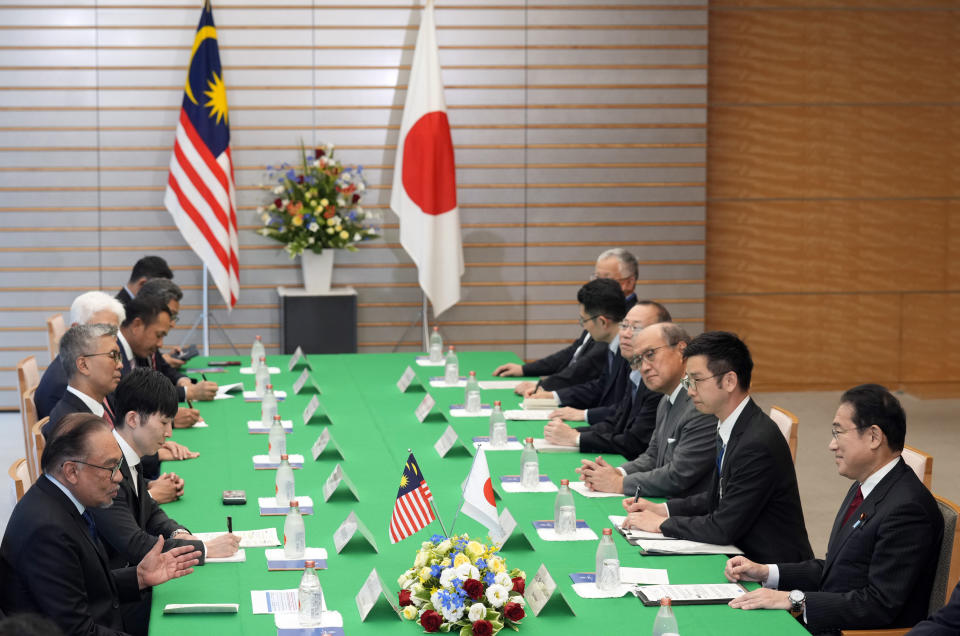 Japanese Prime Minister Fumio Kishida, right, and Malaysian Prime Minister Anwar Ibrahim, left, speak at the start of their meeting at the prime minister's office in Tokyo, Thursday, May 23, 2024. (Franck Robichon/Pool Photo via AP)