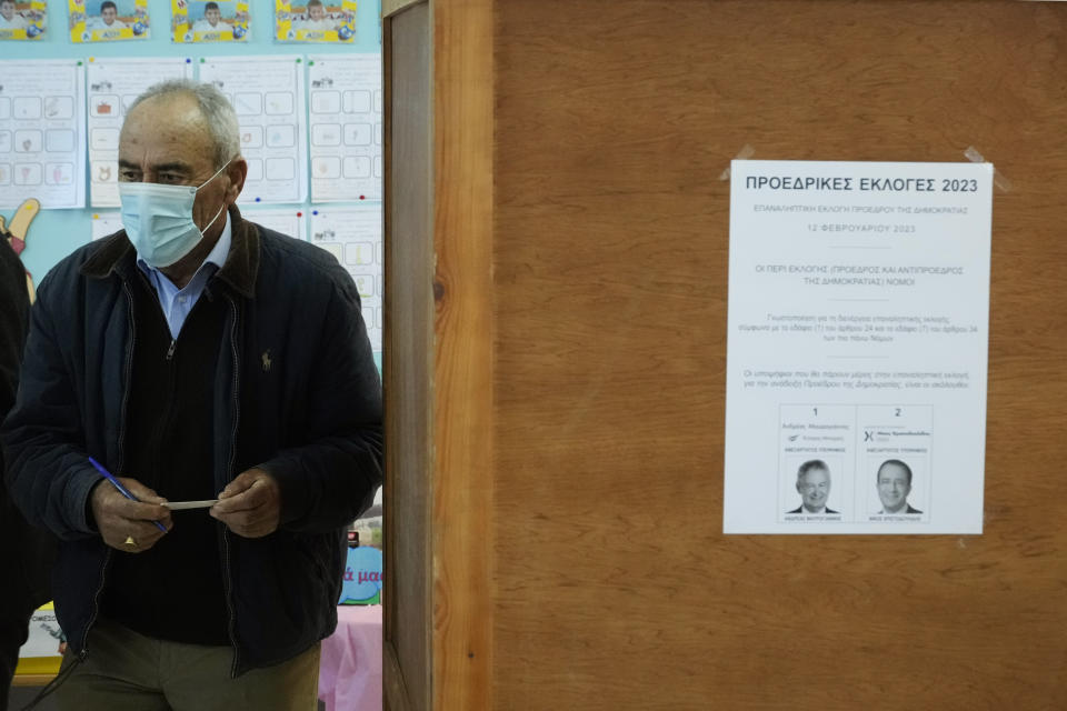 A man leaves the voting booth during the presidential elections in Geroskipou in south west coastal city of Paphos, Cyprus, Sunday, Feb. 12, 2023. Voting has started in a runoff to elect ethnically split Cyprus' eighth new president, pitting a former foreign minister who campaigned as a unifier eschewing ideological and party divisions against a popular veteran diplomat. Some 561,000 citizens are eligible to vote Sunday and both Nikos Christoulides, the ex-foreign minister and Andreas Mavroyiannis are hoping for a higher turnout than the 72% that cast ballots in Feb. 5 first round. (AP Photo/Petros Karadjias)