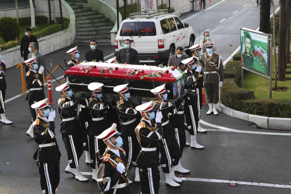 <p>Iranian military personnel carrying the flag-draped coffin of nuclear scientist Mohsen Fakhrizadeh</p> (AP)