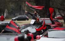 Newell's Old Boys soccer club fans take part in a caravan in the hometown of soccer star Leonel Messi, in Rosario, Argentina, Thursday, Aug. 27, 2020. Fans hope to lure him home following his announcement that he wants to leave Barcelona F.C. after nearly two decades with the Spanish club. (AP Photo/Natacha Pisarenko)