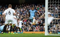 <p>Gabriel Jesus of Manchester City scores his sides first goal during the Premier League match between Manchester City and Swansea City at Etihad Stadium on February 5, 2017 in Manchester, England. </p>