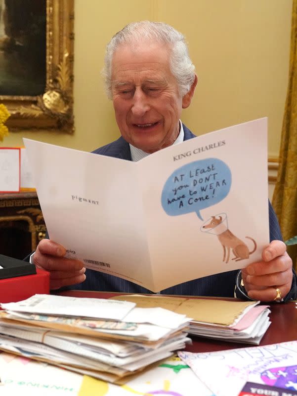 Britain's King Charles reads cards and message, in London