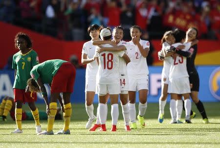 Jun 20, 2015; Edmonton, Alberta, CAN; China midfielder Han Peng (18) celebrates with forward Zhao Rong (14) after defeating Cameroon in the round of sixteen in the FIFA 2015 women's World Cup soccer tournament at Commonwealth Stadium. China won 1-0. Michael Chow-USA TODAY Sports