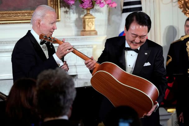 PHOTO: President Joe Biden surprises South Korea's President Yoon Suk Yeol with a guitar signed by Don McLean in the State Dining Room of the White House, April 26, 2023, following the state dinner. (Susan Walsh/AP)