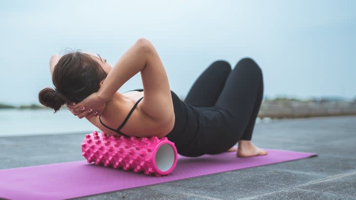 Woman Foam Rolling Upper Back