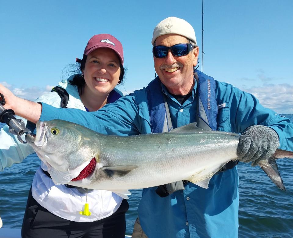 Shaina Boyle of Smithfield caught a 36-inch bluefish, held up here by Capt. Dave Monti, while fishing with her father.