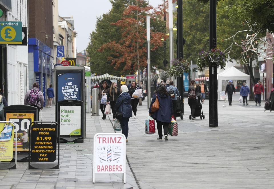 Shoppers on the High Street in Slough as the Berkshire town has been put back onto the government watch list because of a rise in coronavirus cases.