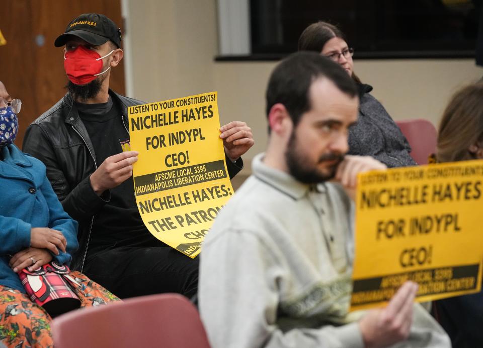 Stephen Lane holds a sign that reads 'Nichelle Hayes for IndyPL CEO!" during a board meeting on Thursday, Dec. 8, 2022 at The Indianapolis Public Library Foundation in Indianapolis.