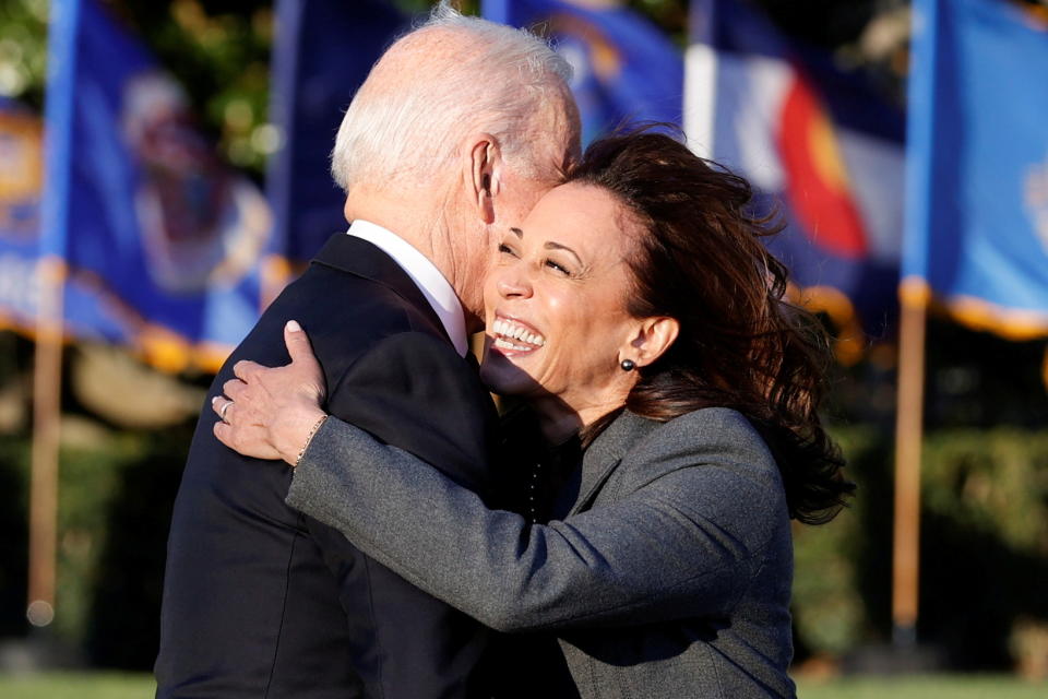 U.S. President Joe Biden and Vice-President Kamala Harris hug each other during a ceremony to sign the 
