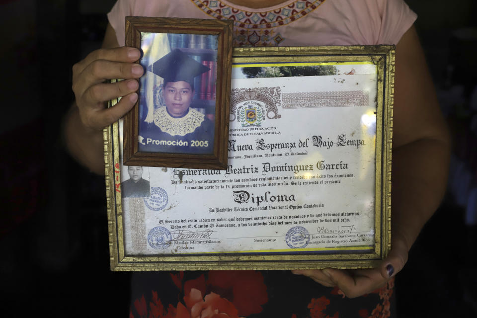 Maria Dolores Garcia holds a photo of her daughter Esmeralda Dominguez and her Bachelor of Commerce diploma, at her home in the Sisiguayo community in Jiquilisco, in the Bajo Lempa region of El Salvador, Thursday, May 12, 2022. Dominguez, who was picked up by a group of soldiers and police on April 19 during anti-gang operation backed by the state of emergency decreed by the government of President Nayib Bukele, is well-known in the community and has worked together with officers at the local police station on a youth program to prevent violence. (AP Photo/Salvador Melendez)
