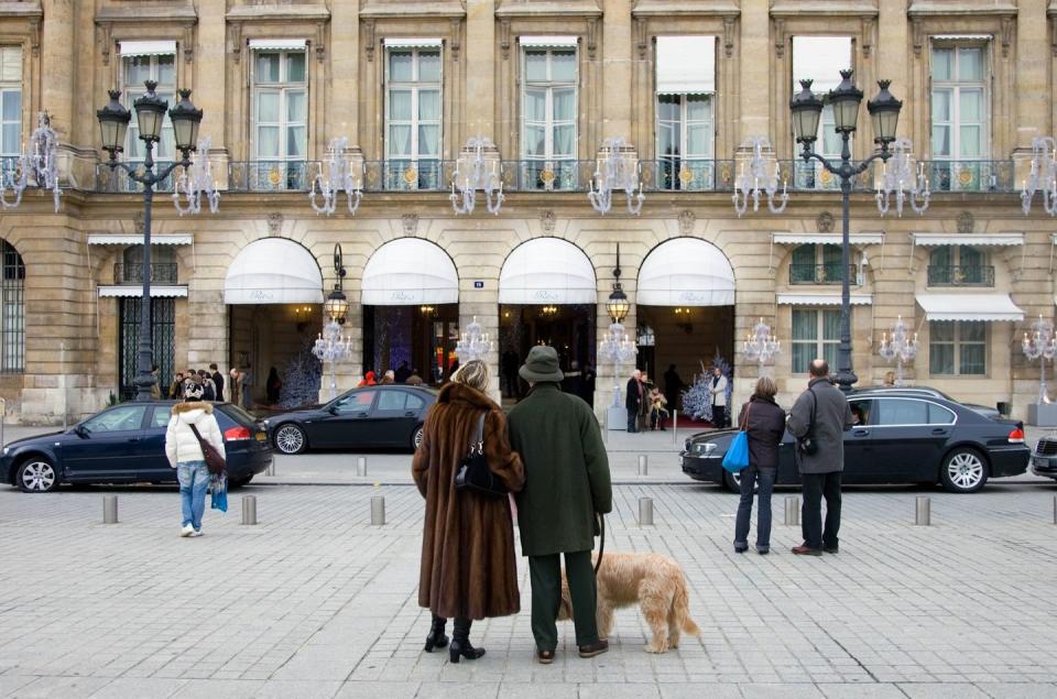 A couple with a dog stand outside the hotel in 2007