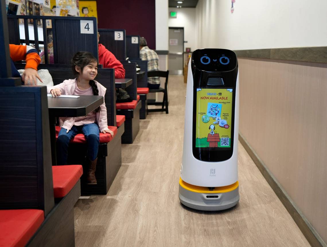 A robot twirls through Kura Revolving Sushi Bar in Columbus, Ohio, on Jan. 18, 2024. The chain serves food via conveyor belts and robots and is priced by the plate.