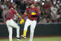 Arizona Diamondbacks designated hitter Joc Pederson, right, celebrates after his two-run home run against the San Diego Padres with third base coach Tony Perezchica (21) during the fourth inning of a baseball game Sunday, May 5, 2024, in Phoenix. (AP Photo/Ross D. Franklin)
