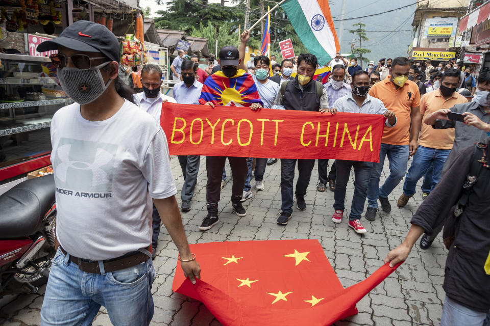 Exile Tibetans and local Indians participate in a protest against the Chinese government in Dharmsala, India, Friday, June 19, 2020. India said Thursday it was using diplomatic channels with China to de-escalate a military standoff in a remote Himalayan border region where 20 Indian soldiers were killed this week. (AP Photo/Ashwini Bhatia)