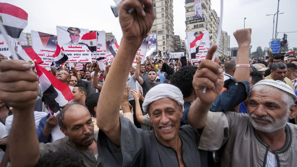 Supporters of Egyptian President Abdel Fattah el-Sisi carry his posters during a march in Cairo, Egypt on October 2. - Amr Nabil/AP