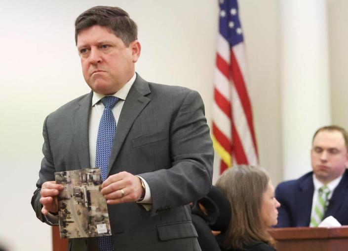 Assistant Tarrant County Criminal District Attorney Dale Smith shows the jury evidence while cross-examining Aaron Dean on Monday, December 12, 2022, in Fort Worth. Dean, a former Fort Worth police officer, fatally shot Atatiana Jefferson in 2019 through her bedroom window.