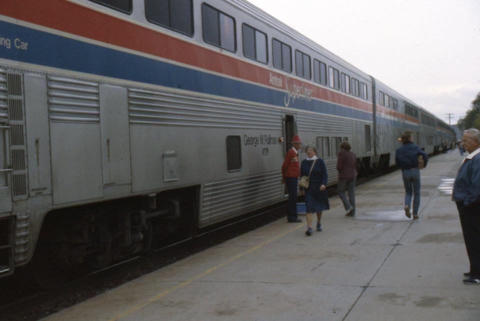 silver exterior of Amtrak train in 1984 with red and blue stripes