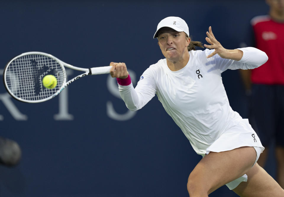 Iga Swiatek, of Poland, hits a return to Danielle Collins, of the United States, during the National Bank Open women’s tennis tournament Friday, Aug. 11, 2023, in Montreal. (Christinne Muschi/The Canadian Press via AP)