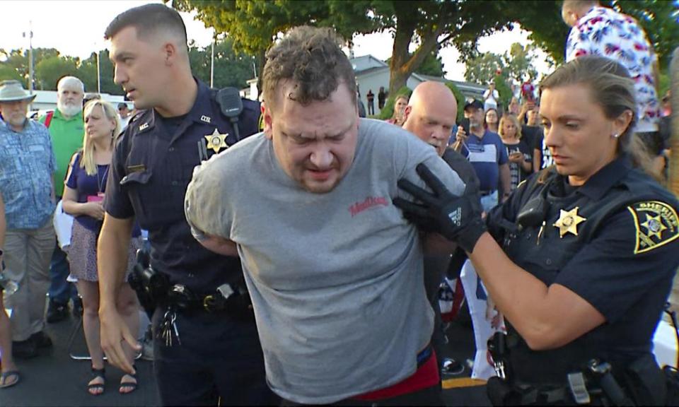 A suspect is taken into custody by sheriff deputies after he brandished a sharp object during an attack on Lee Zeldin, the Republican candidate for New York governor, in Perinton in July.