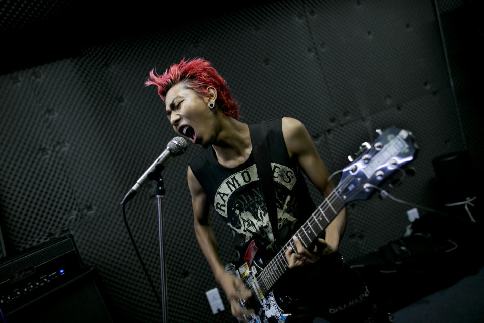 In this Tuesday, July 9, 2013 photo, Kyaw Kyaw, lead singer of punk rock band Rebel Riot, rehearses with his group members in a Yangon studio, Myanmar. Punk rockers draw double-takes as they dart through traffic, but it's not the pink hair, leather jackets, or skull tattoos that make these 20-somethings rebels: It's their willingness to speak out against Buddhist monks instigating violence against Muslims while others in Myanmar are silent. “If they were real monks, I’d be quiet, but they aren't,” says Kyaw Kyaw, as his drummer knocks out the beat for a new song slamming religious hypocrisy and an anti-Muslim movement known as “969.” “They are nationalists, fascists. No one wants to hear it, but it’s true.” (AP Photo/Gemunu Amarasinghe)