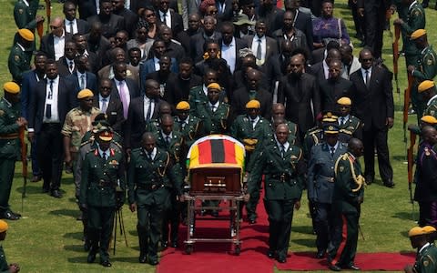 Robert Mugabe's coffin arrives for a state funeral at Harare's national stadium - Credit: &nbsp;Ben Curtis/AP