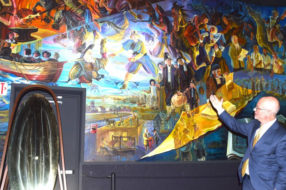 Behalt Executive Director Marcus Yoder describes the connection between the cyclorama mural and Abner Henry creations.