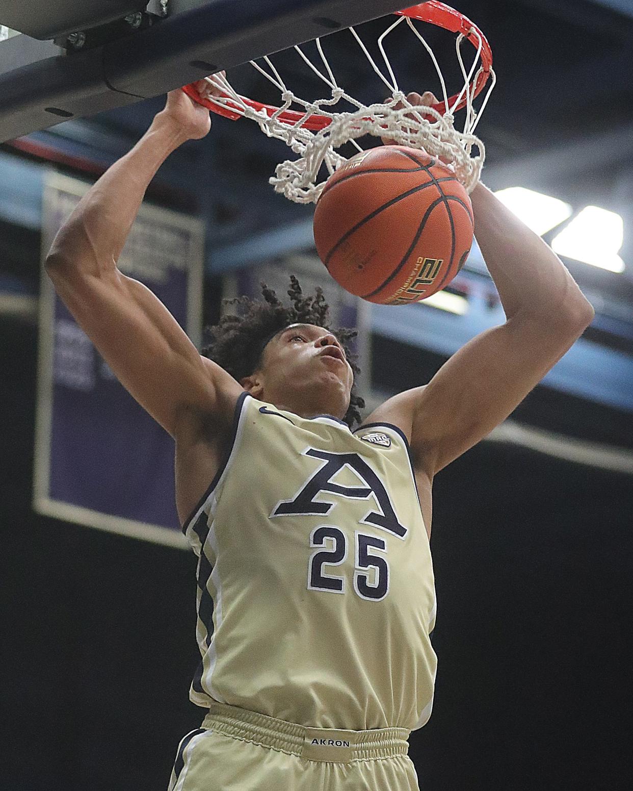 University of Akron's Enrique Freeman slams down a dunk against Gardner-Webb on Thursday, Dec. 21, 2023, in Akron, Ohio. [Phil Masturzo/ Beacon Journal]