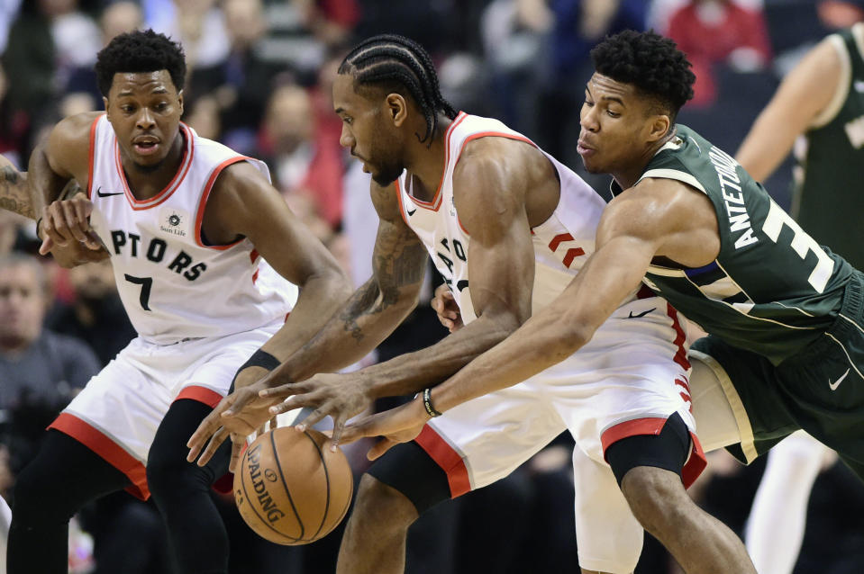 Milwaukee Bucks forward Giannis Antetokounmpo (34) reaches in on Toronto Raptors forward Kawhi Leonard (2) during the first half of Game 4 of the NBA basketball playoffs Eastern Conference finals, Tuesday, May 21, 2019 in Toronto. (Frank Gunn/The Canadian Press via AP)